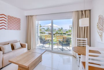 a room with a sliding glass door and chairs