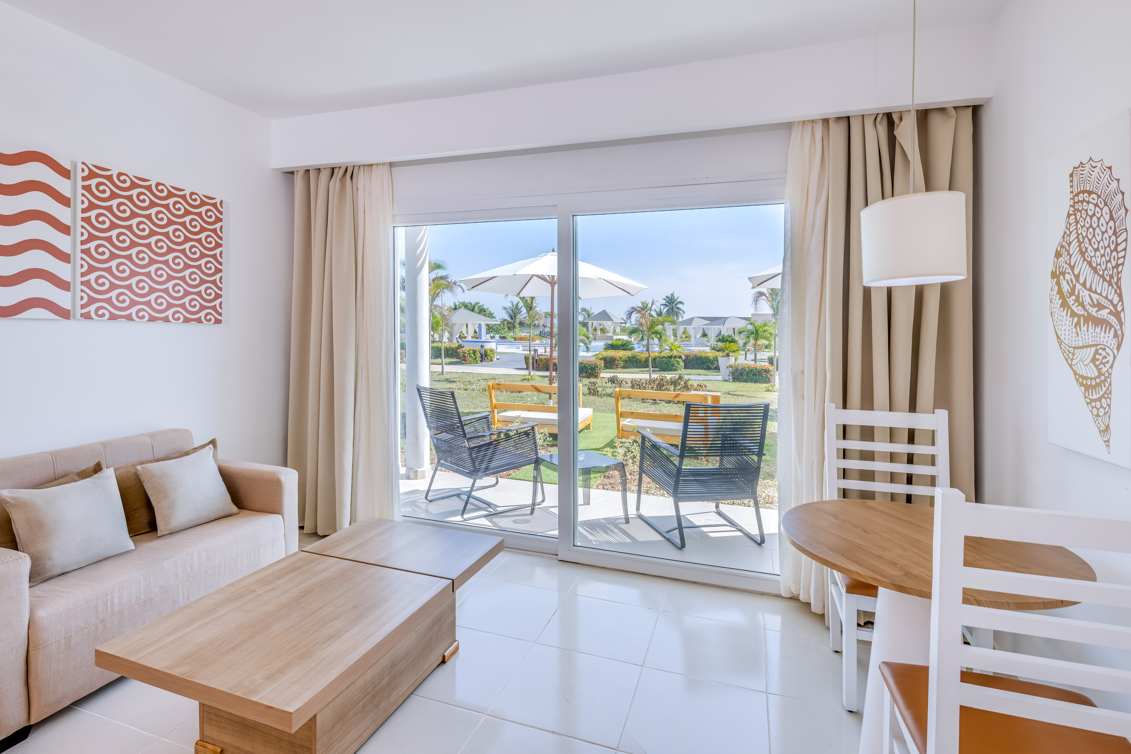 a room with a sliding glass door and chairs