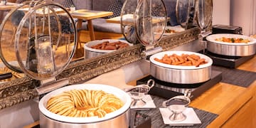 food in a buffet with a mirror