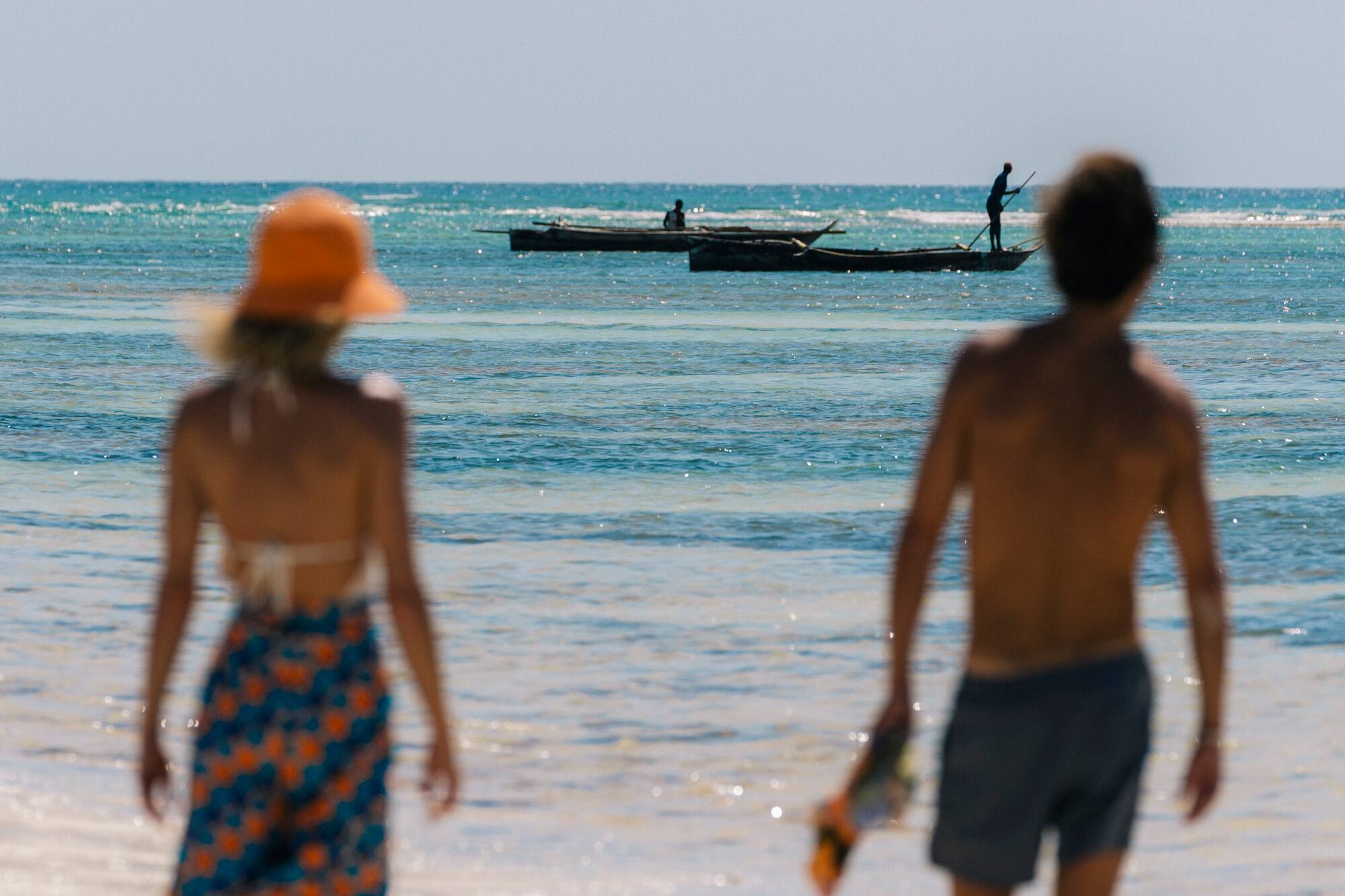 a couple walking on a beach