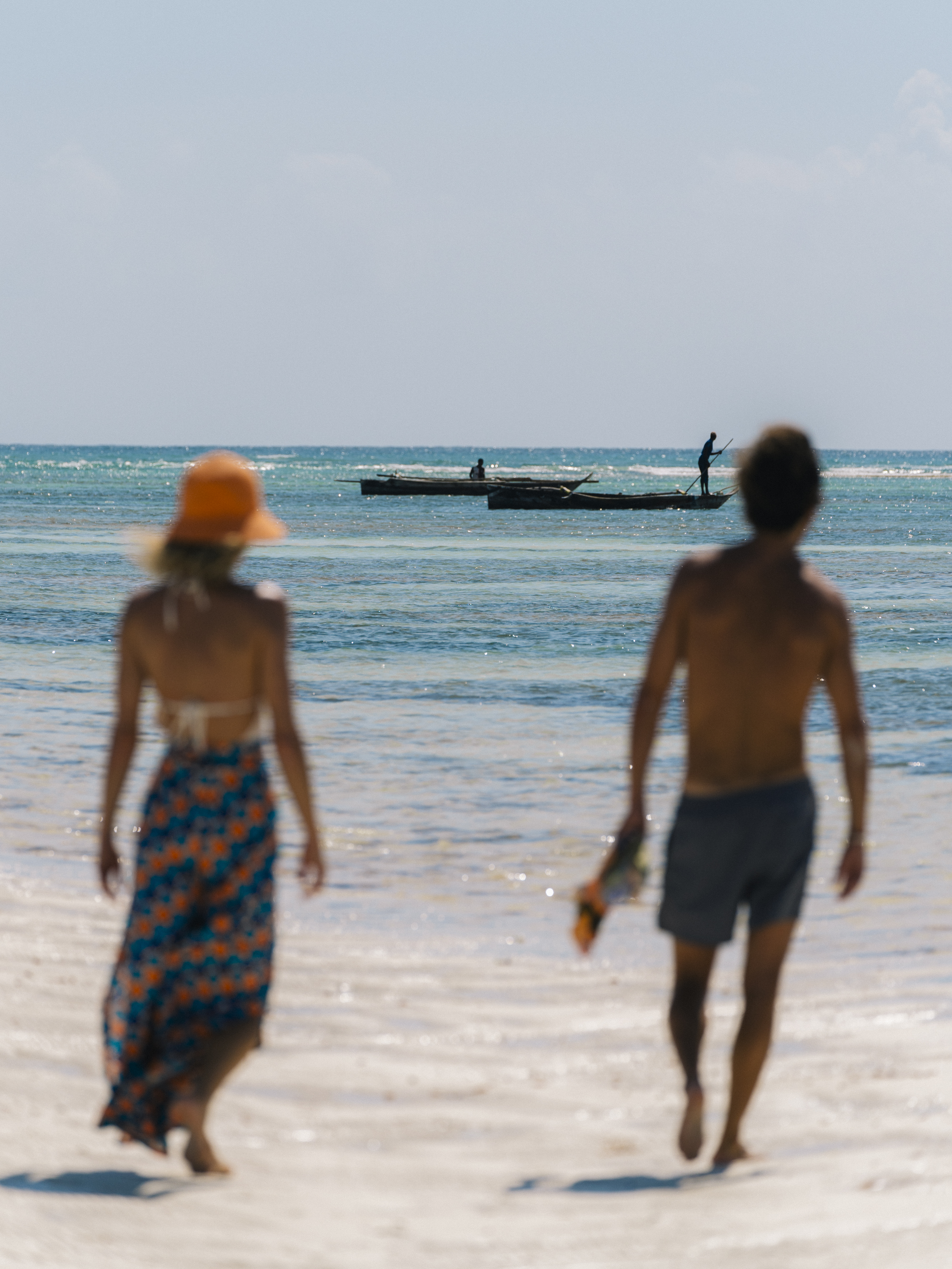 a couple walking on a beach