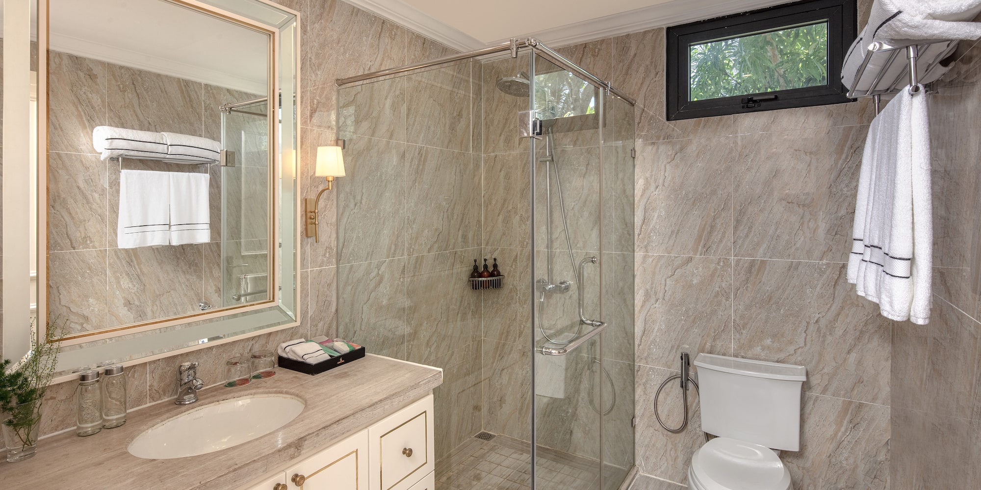 a bathroom with a glass shower and sink
