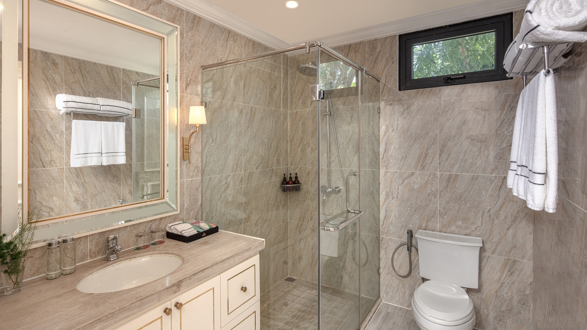 a bathroom with a glass shower and sink