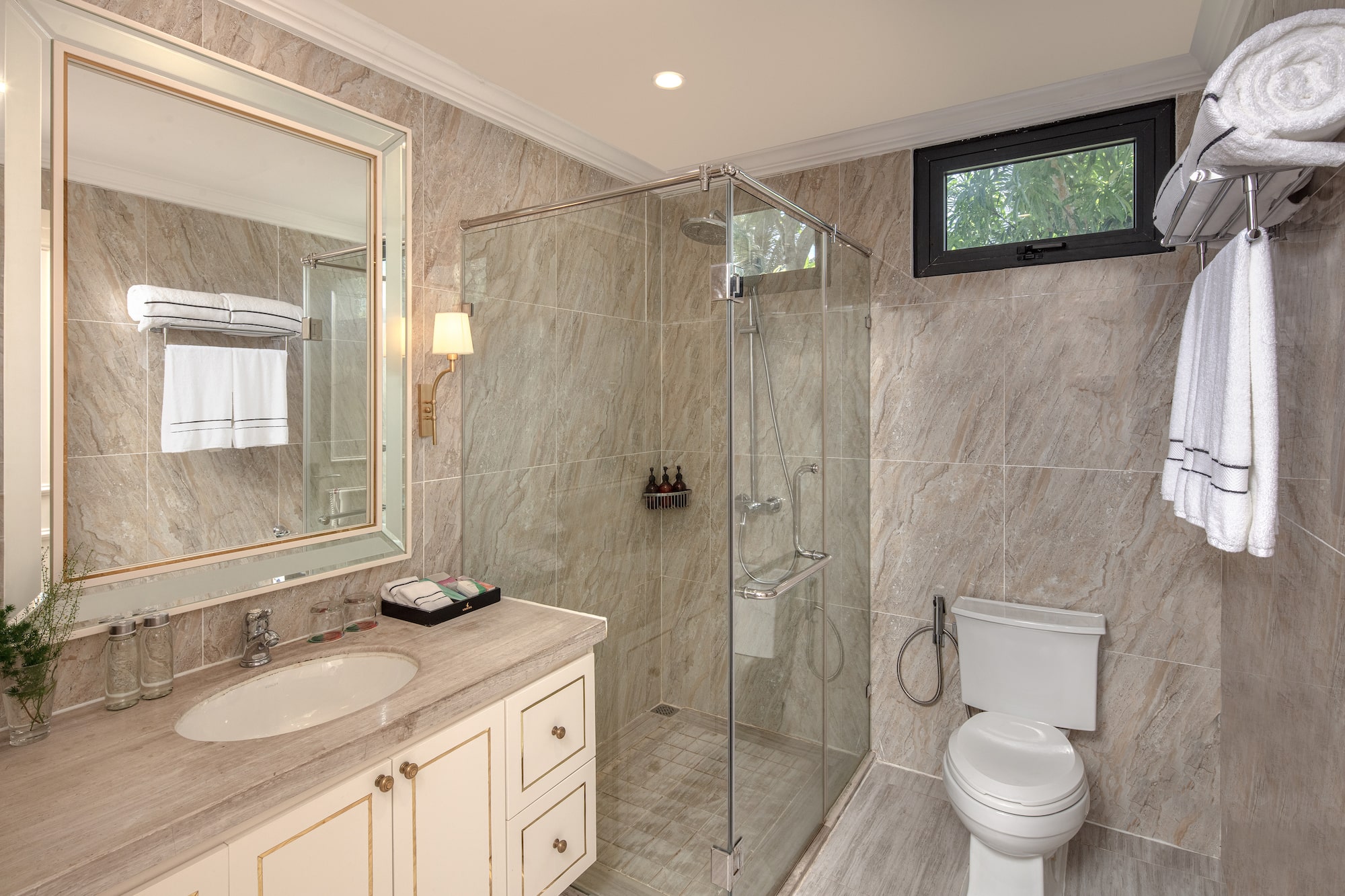 a bathroom with a glass shower and sink
