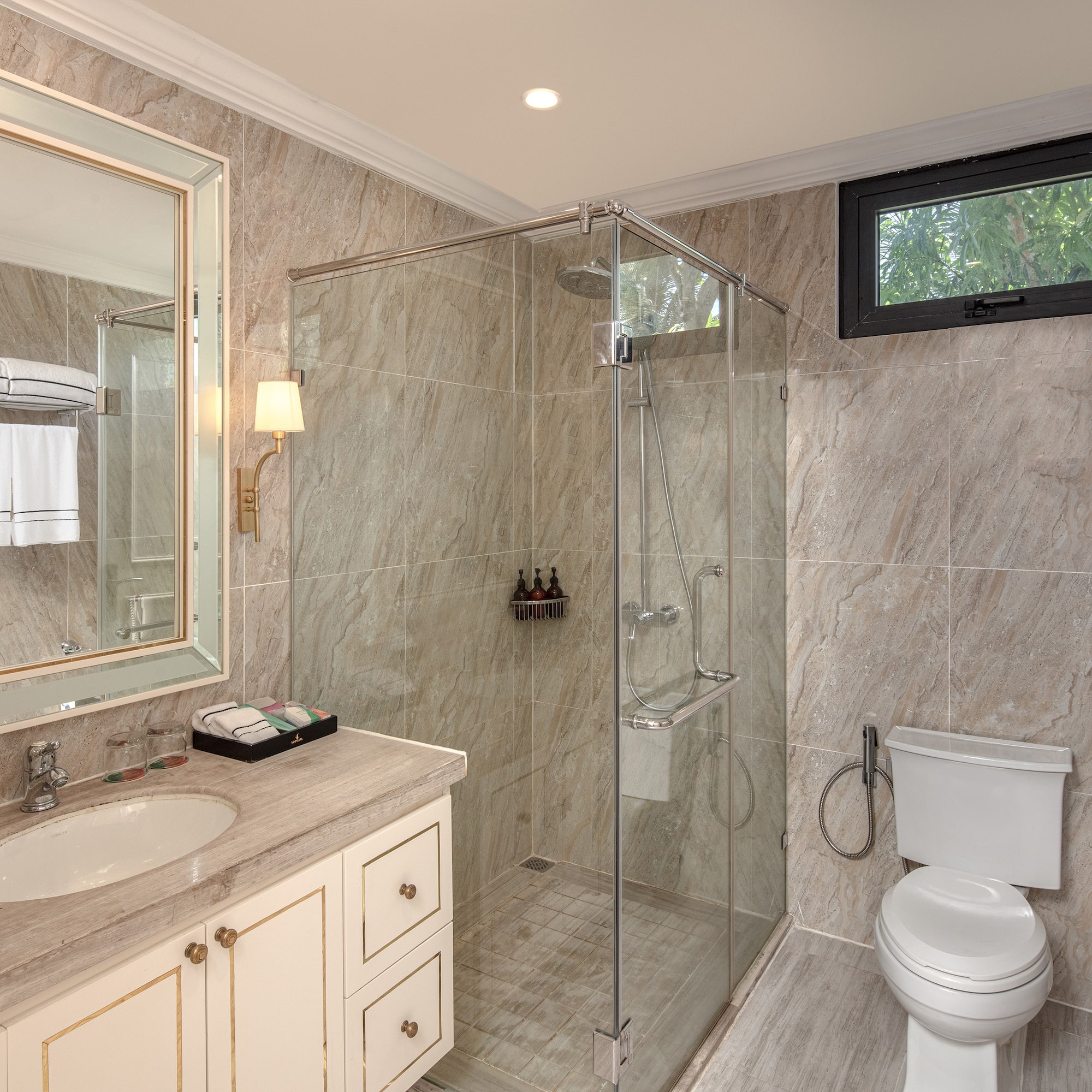 a bathroom with a glass shower and sink