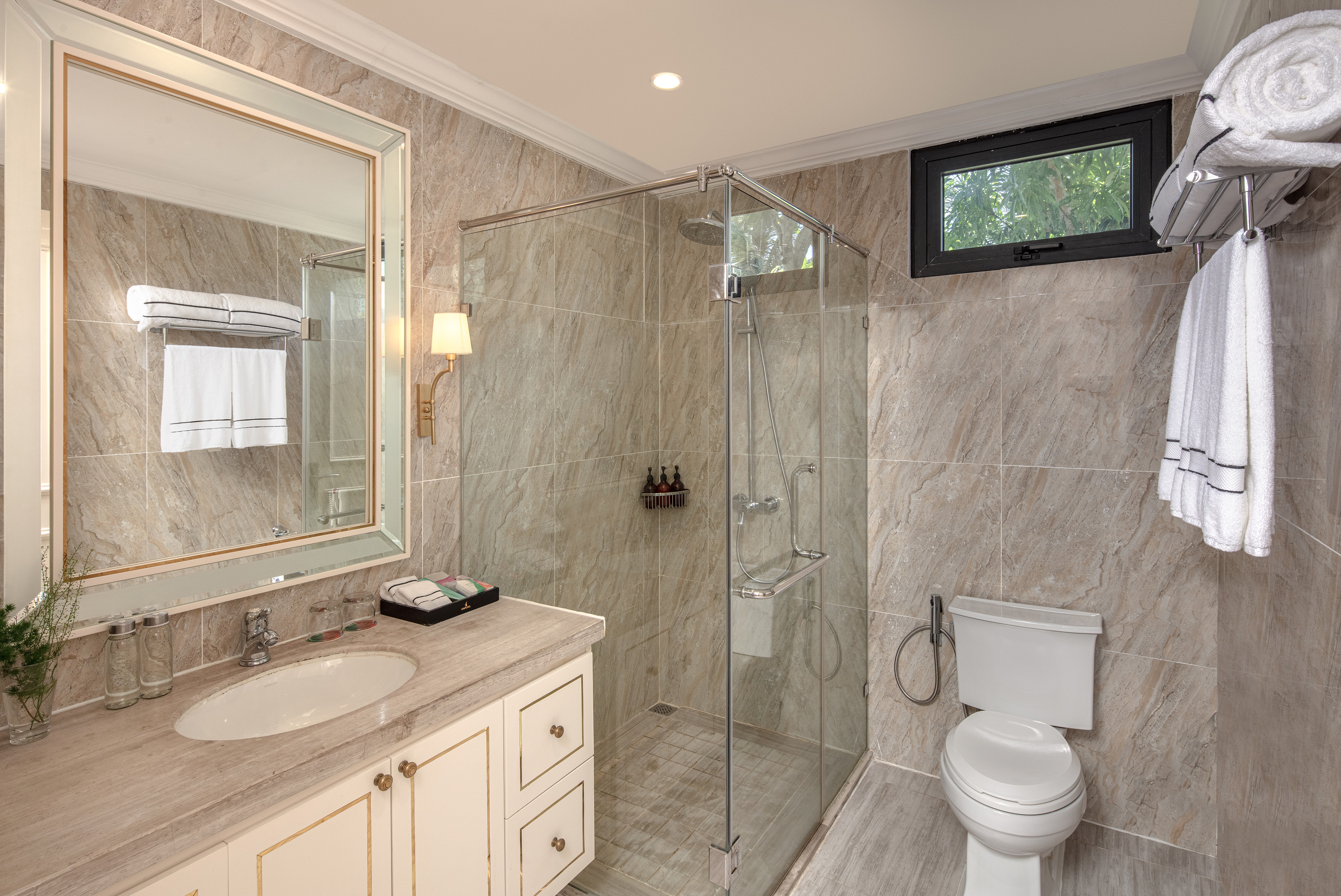 a bathroom with a glass shower and sink