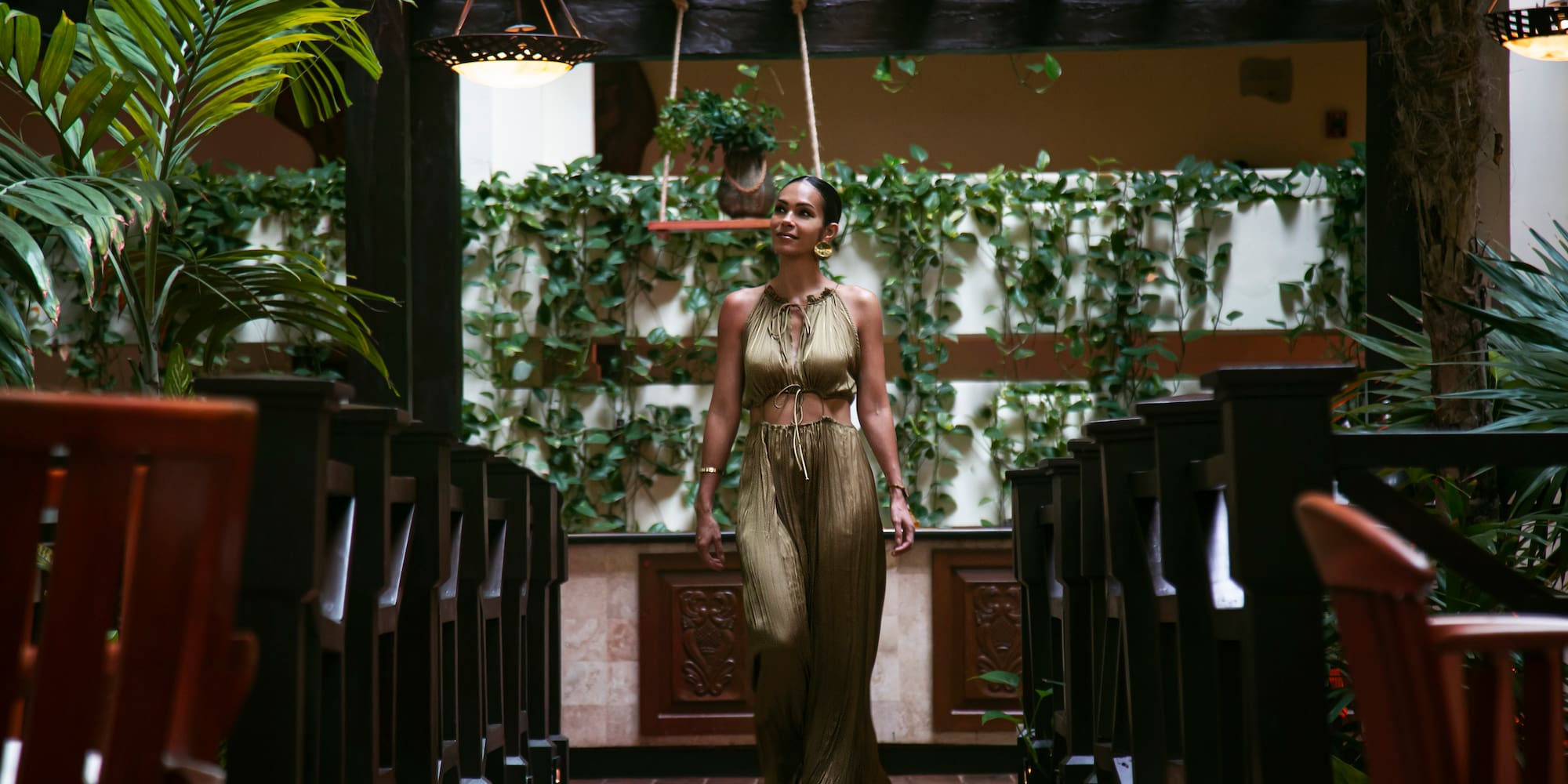 a woman walking in a room with chairs
