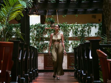 a woman walking in a room with chairs