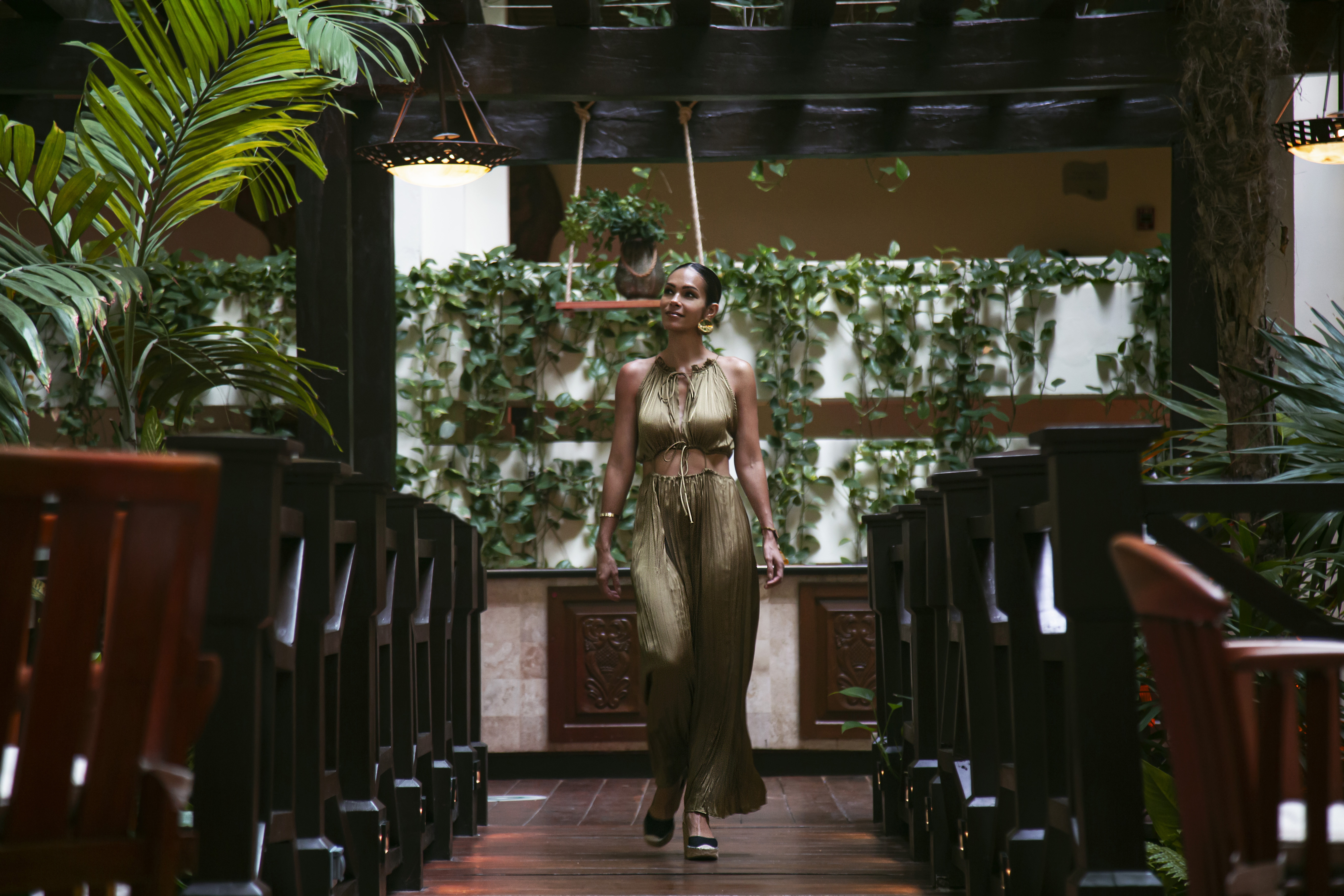 a woman walking in a room with chairs