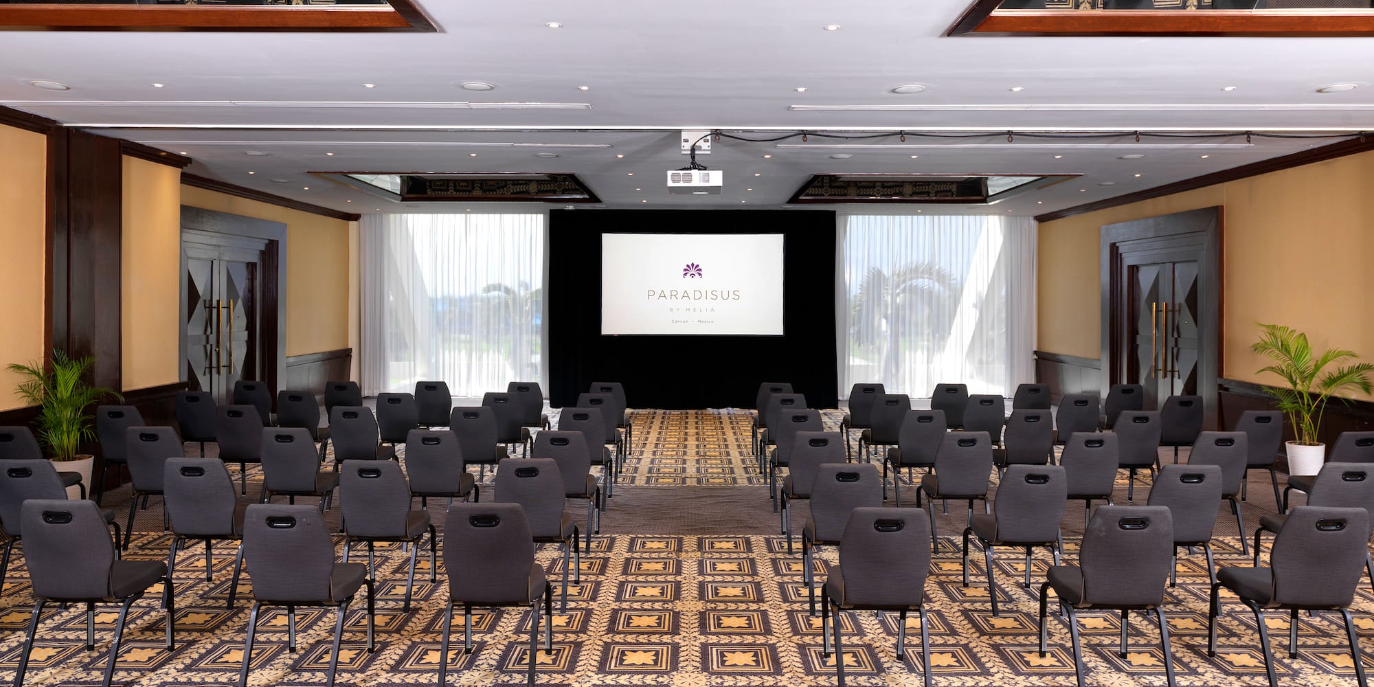 a room with chairs and a projector screen