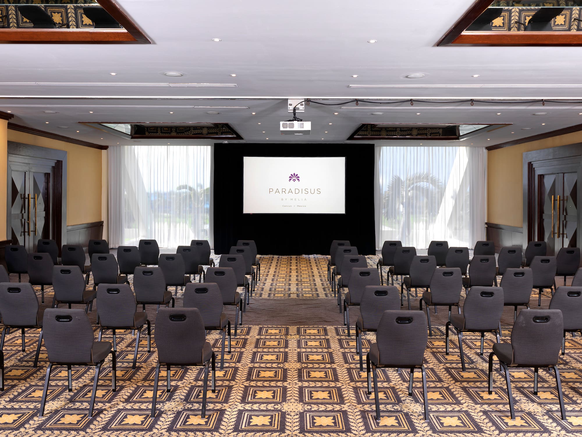 a room with chairs and a projector screen