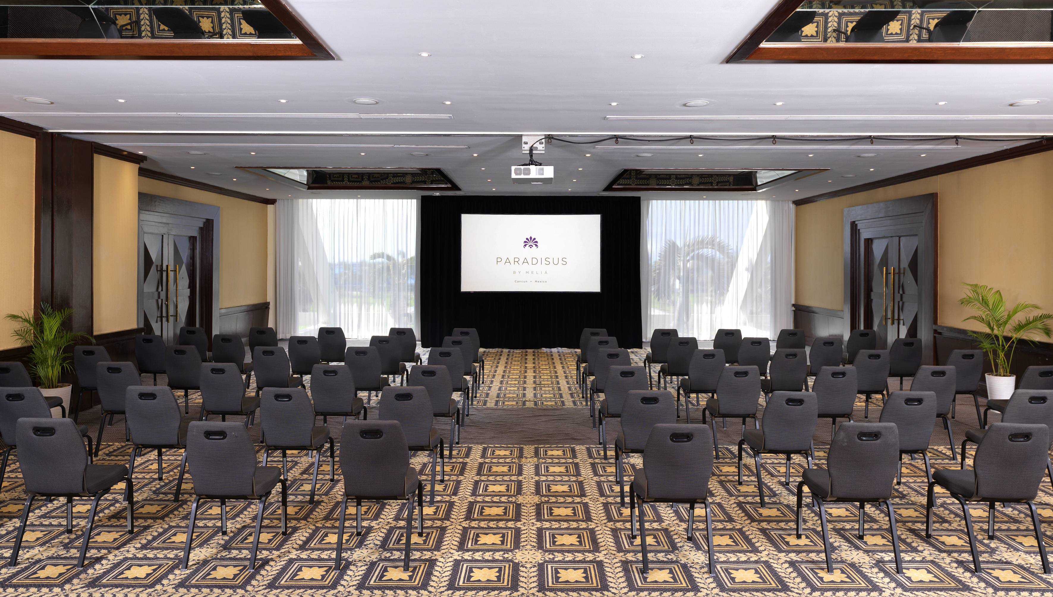 a room with chairs and a projector screen