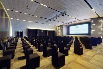 a large room with chairs and a projector screen