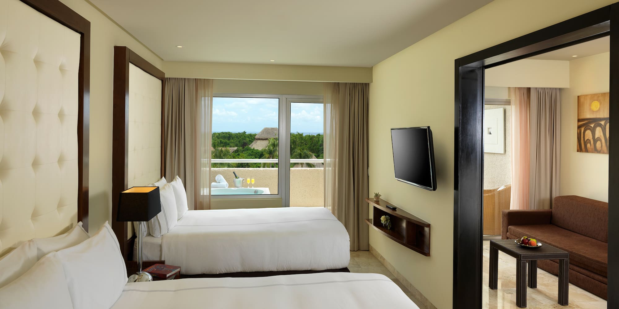 a room with two beds and a television