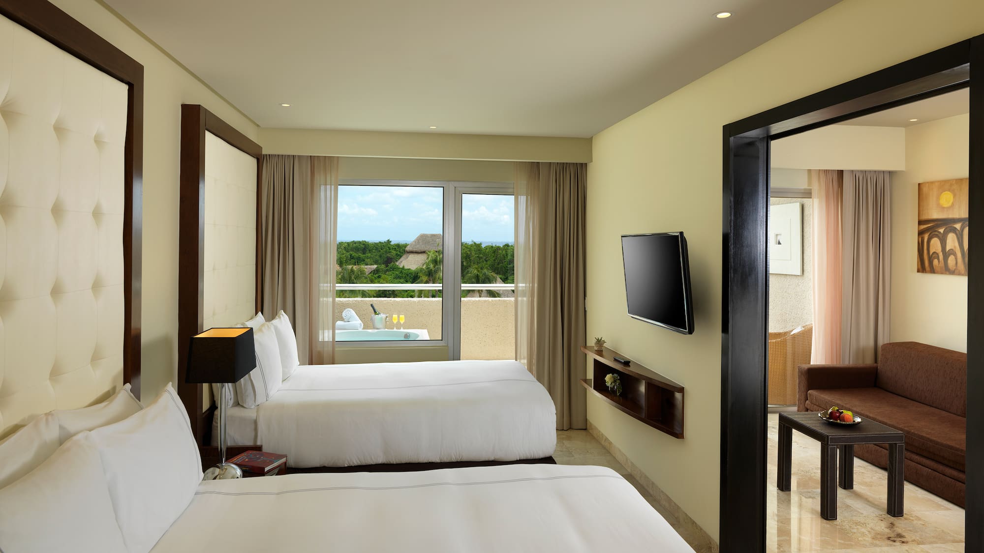 a room with two beds and a television