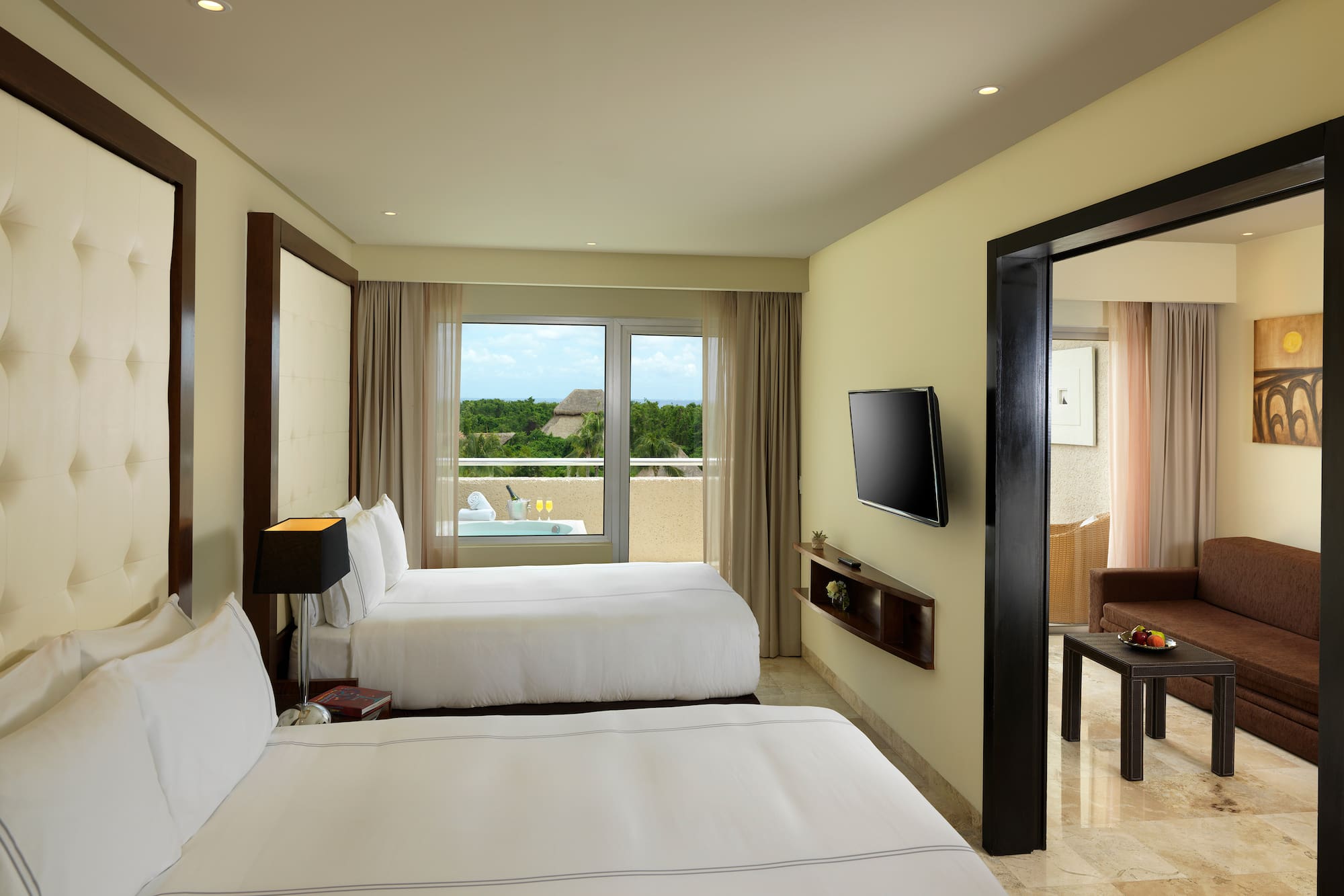 a room with two beds and a television