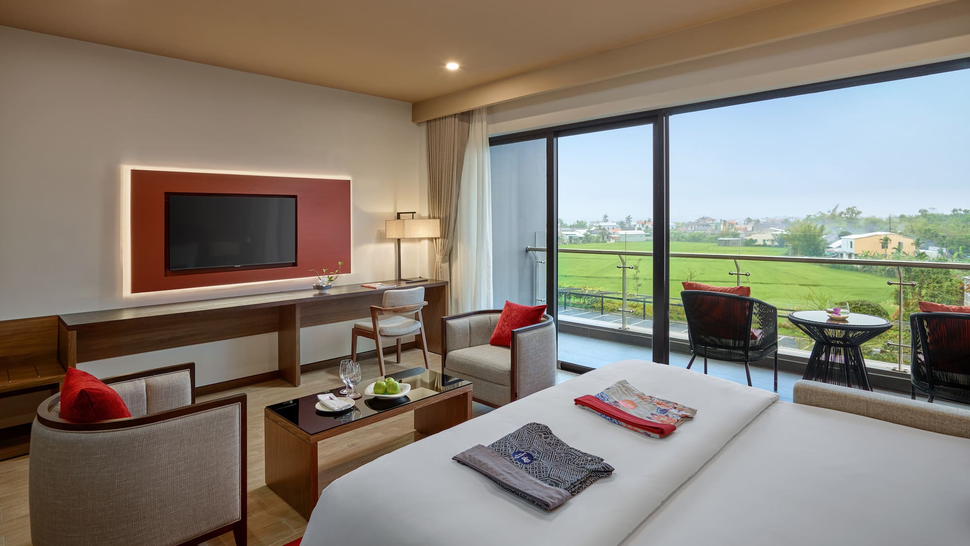 a room with a television and a golf course view