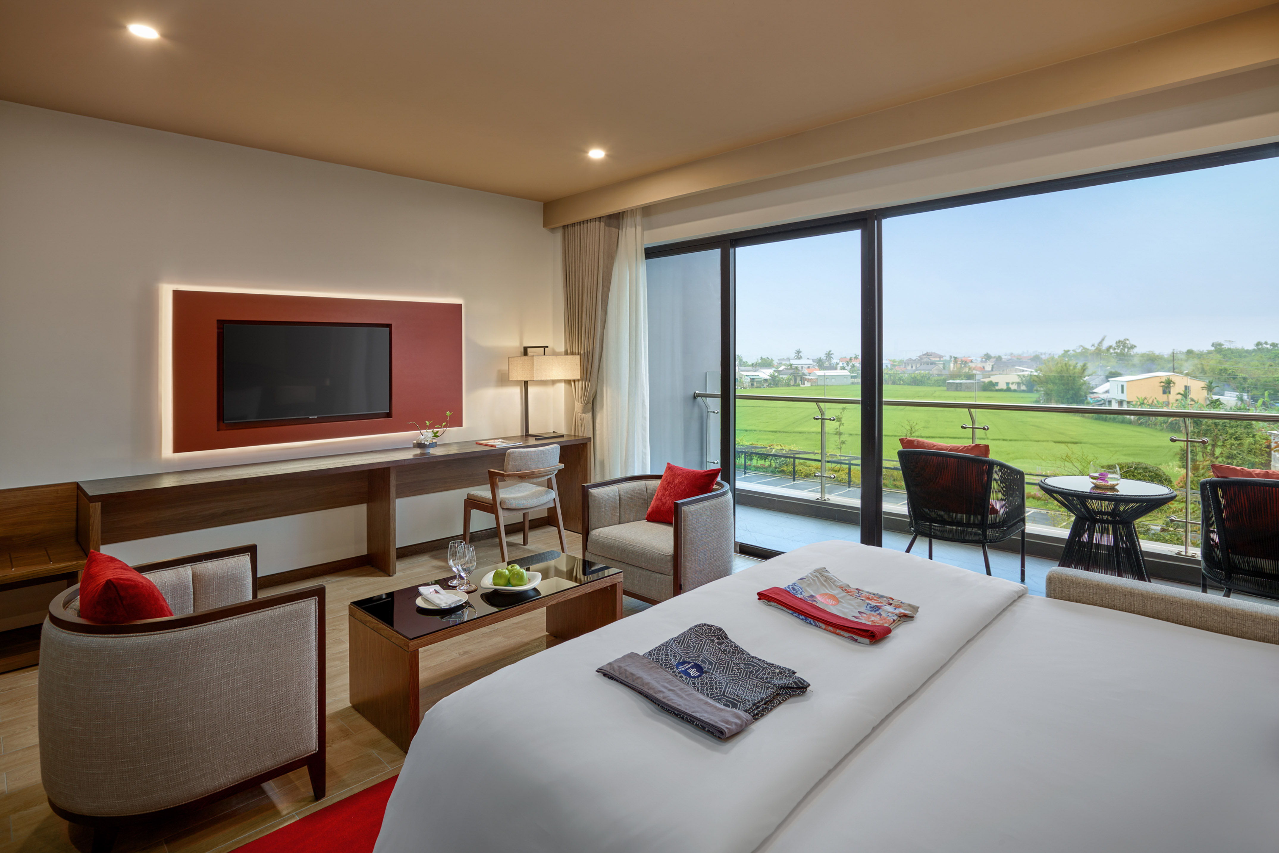 a room with a television and a golf course view