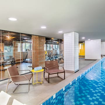 a swimming pool with chairs and a table