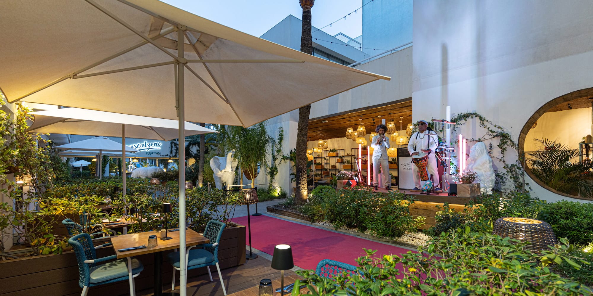 a group of people on stage in front of a building