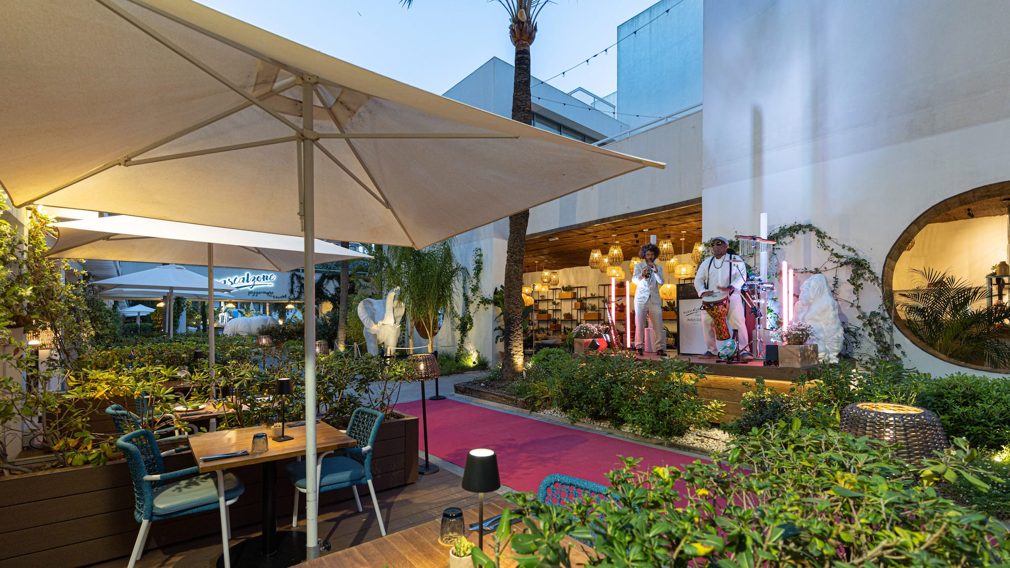 a group of people on stage in front of a building