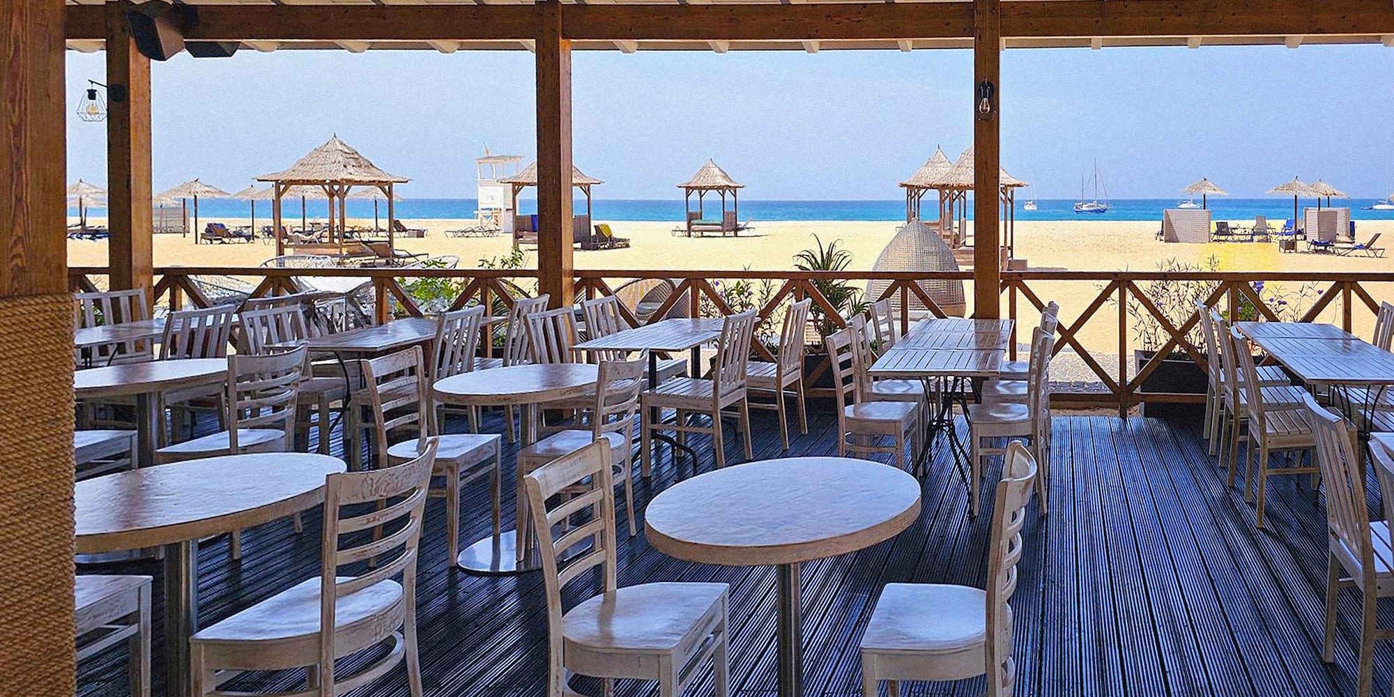 a restaurant with tables and chairs on a deck