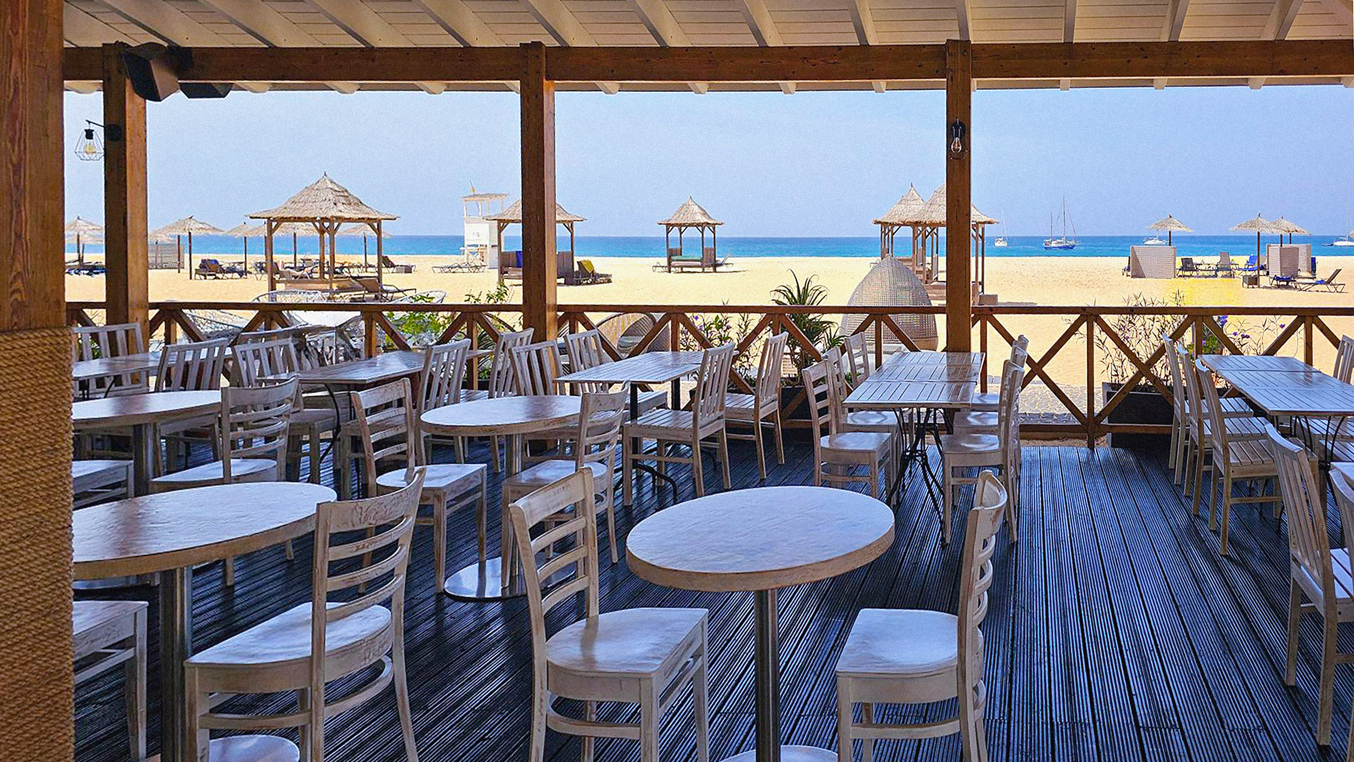 a restaurant with tables and chairs on a deck