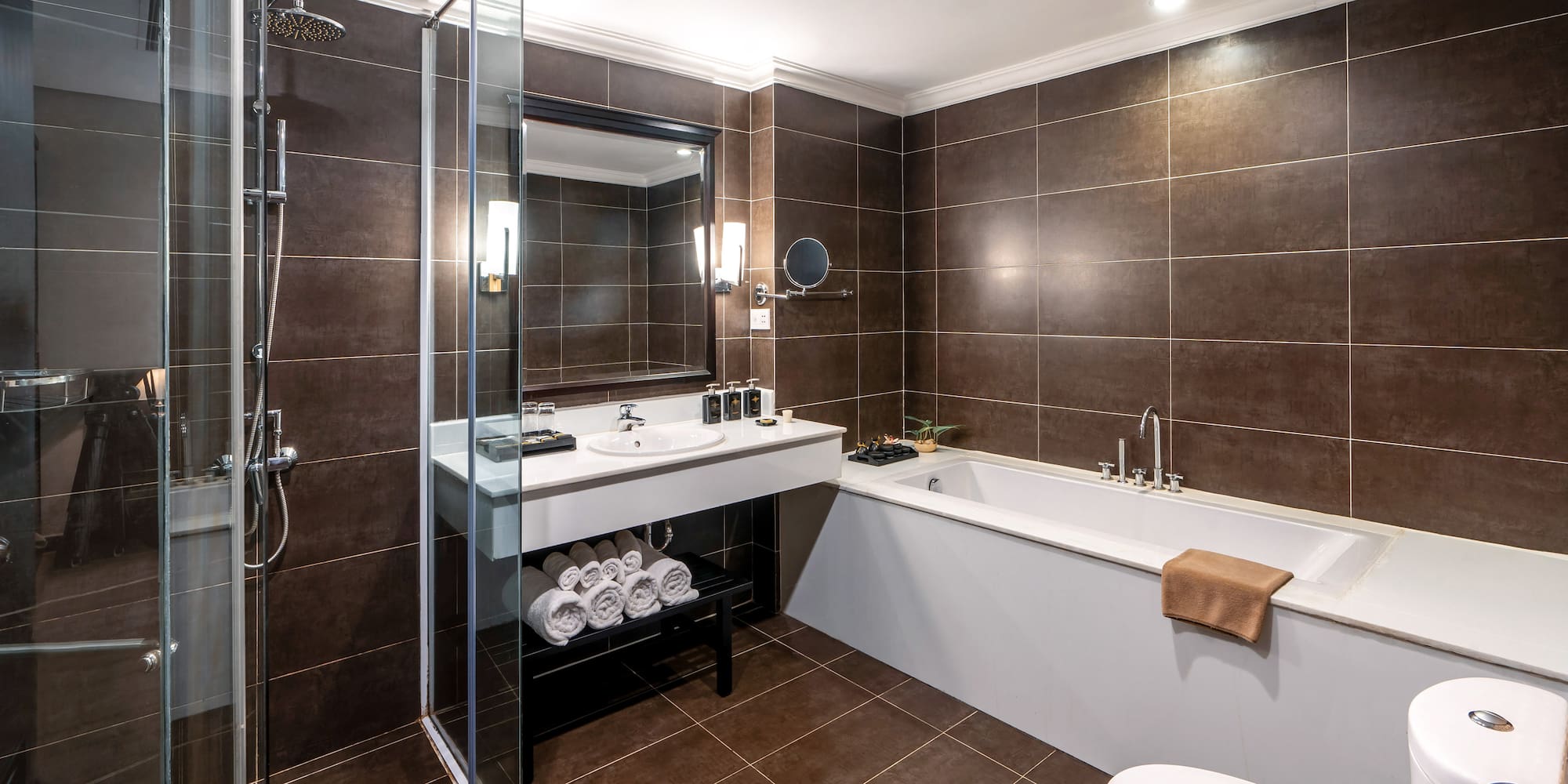a bathroom with brown tile walls