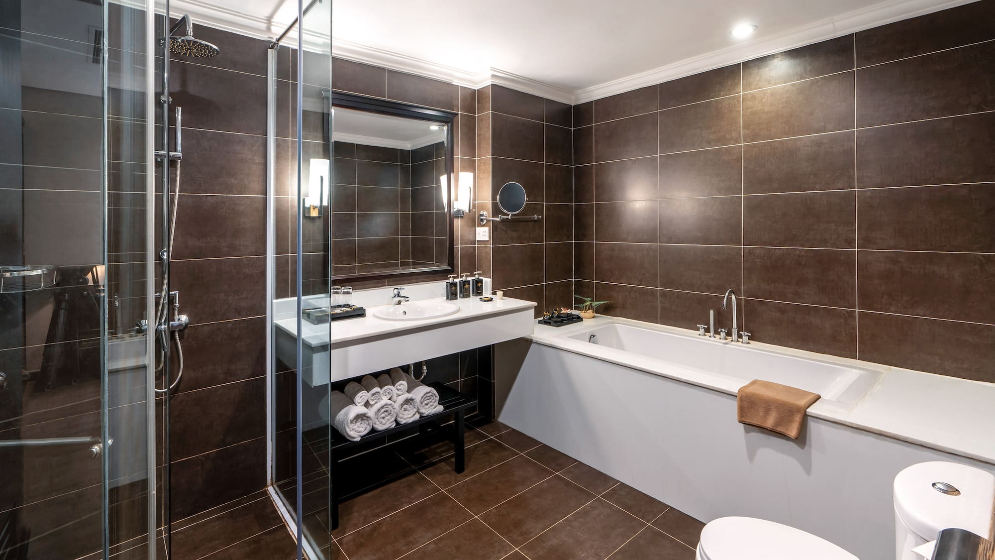a bathroom with brown tile walls