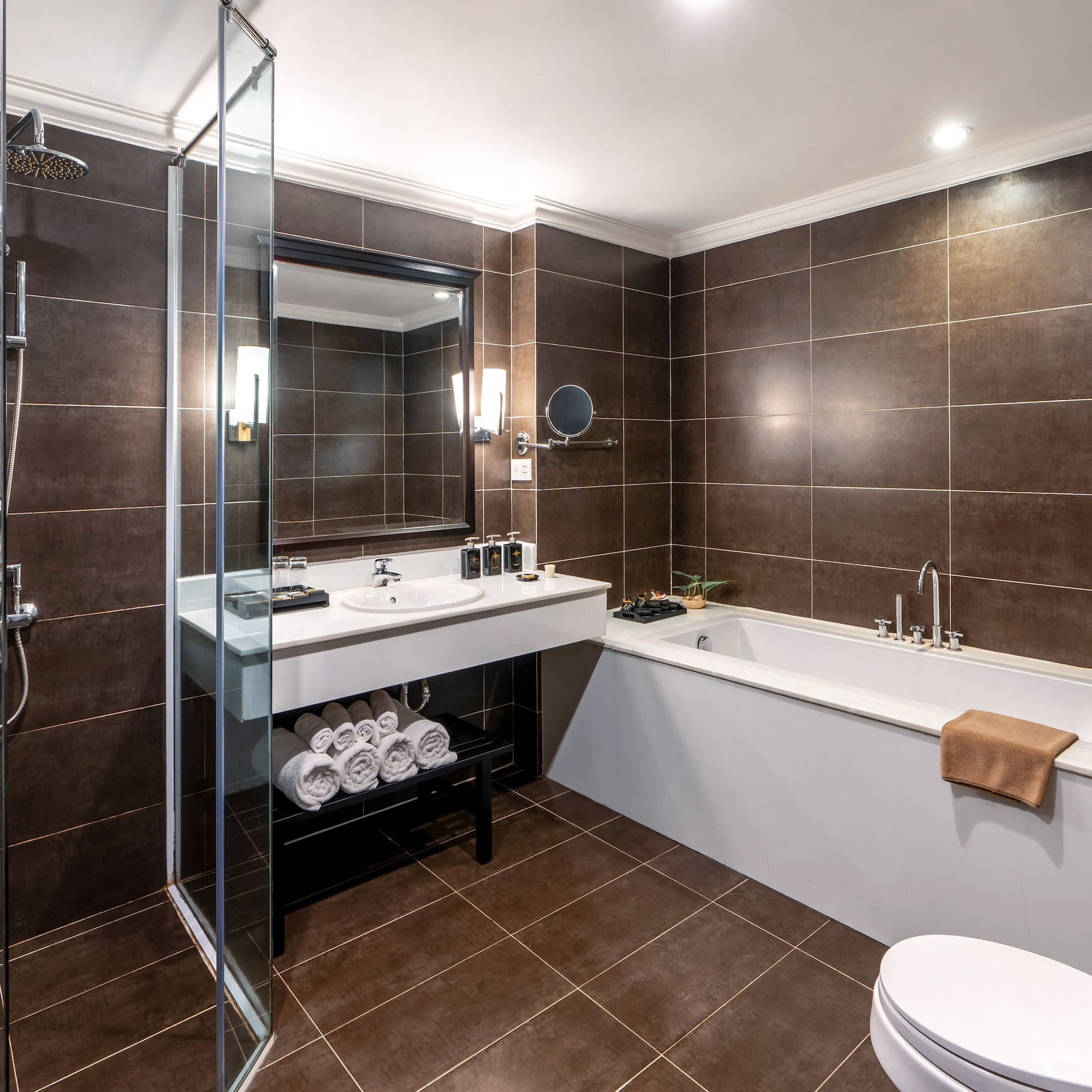 a bathroom with brown tile walls