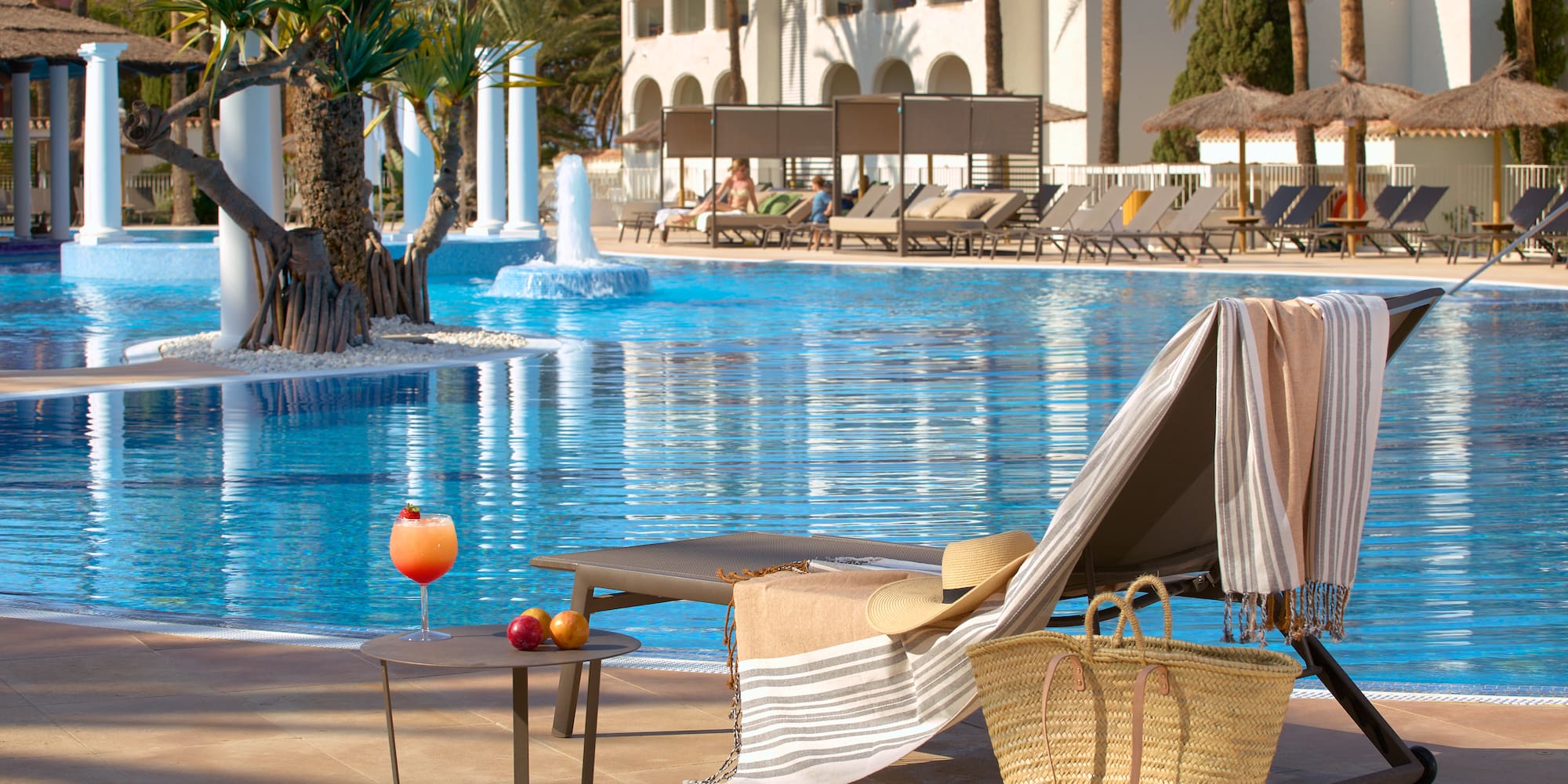a pool with a chair and a table