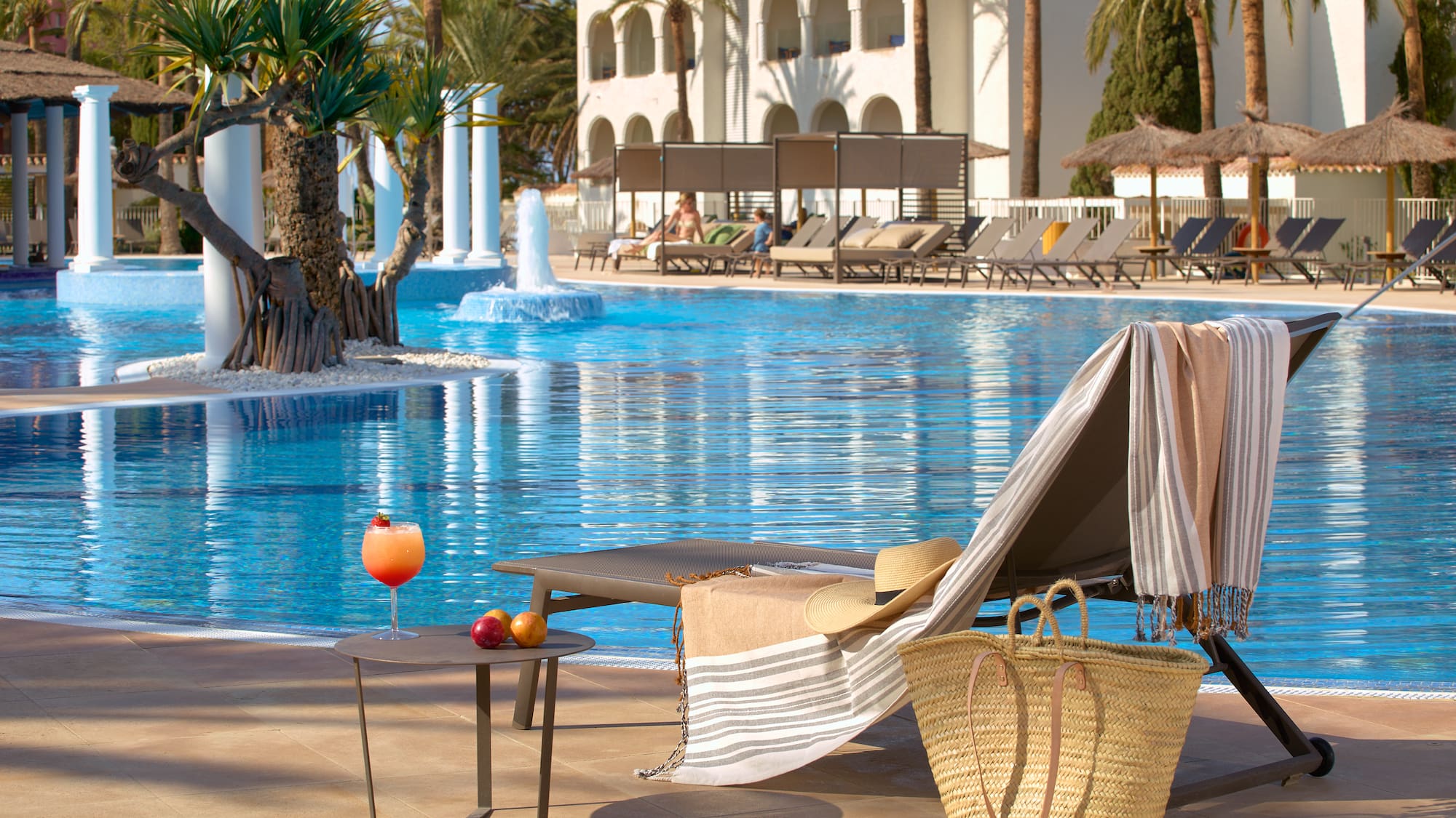 a pool with a chair and a table