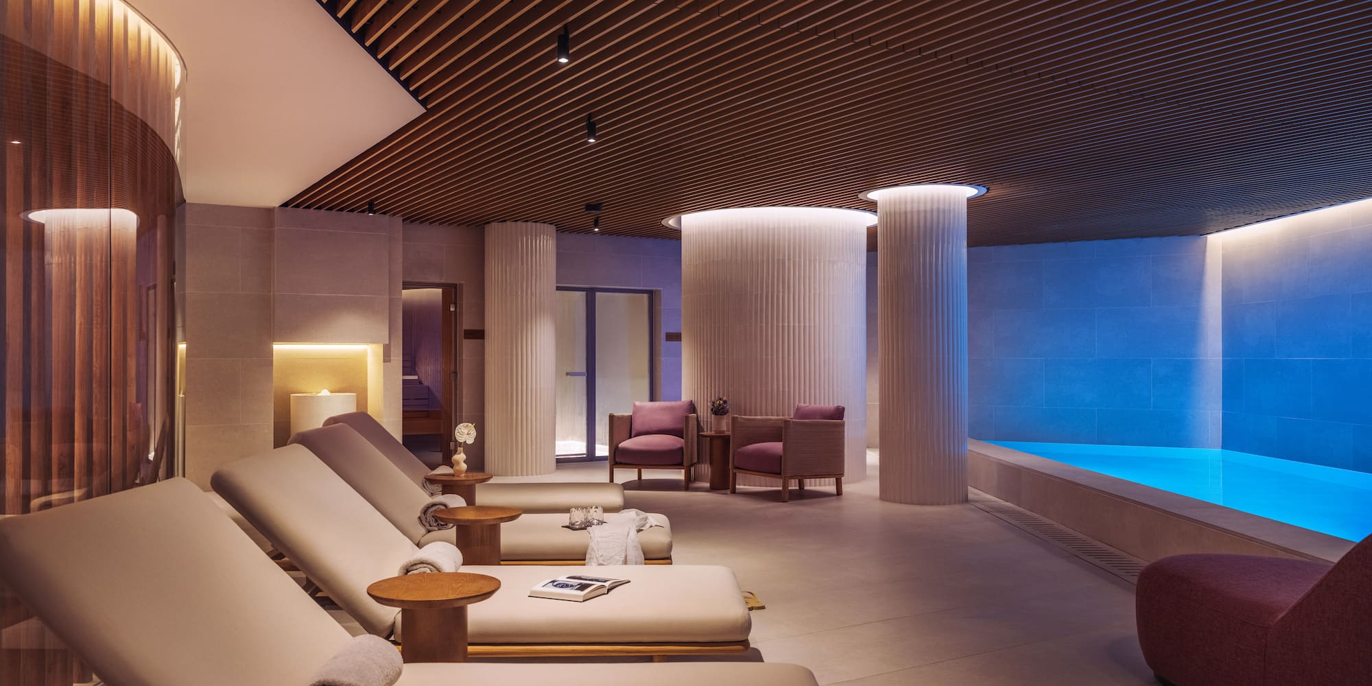 a room with chairs and a pool