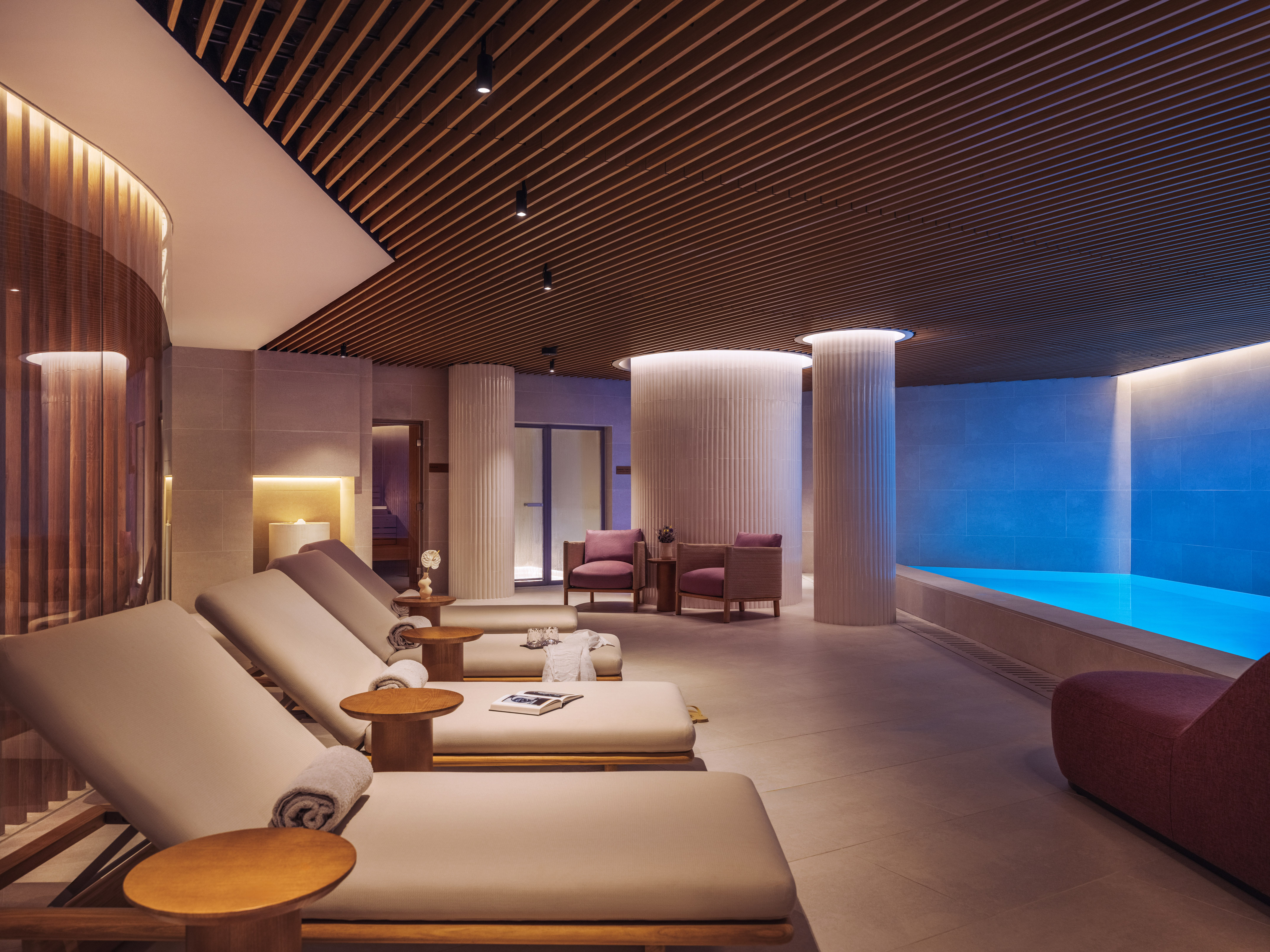a room with chairs and a pool
