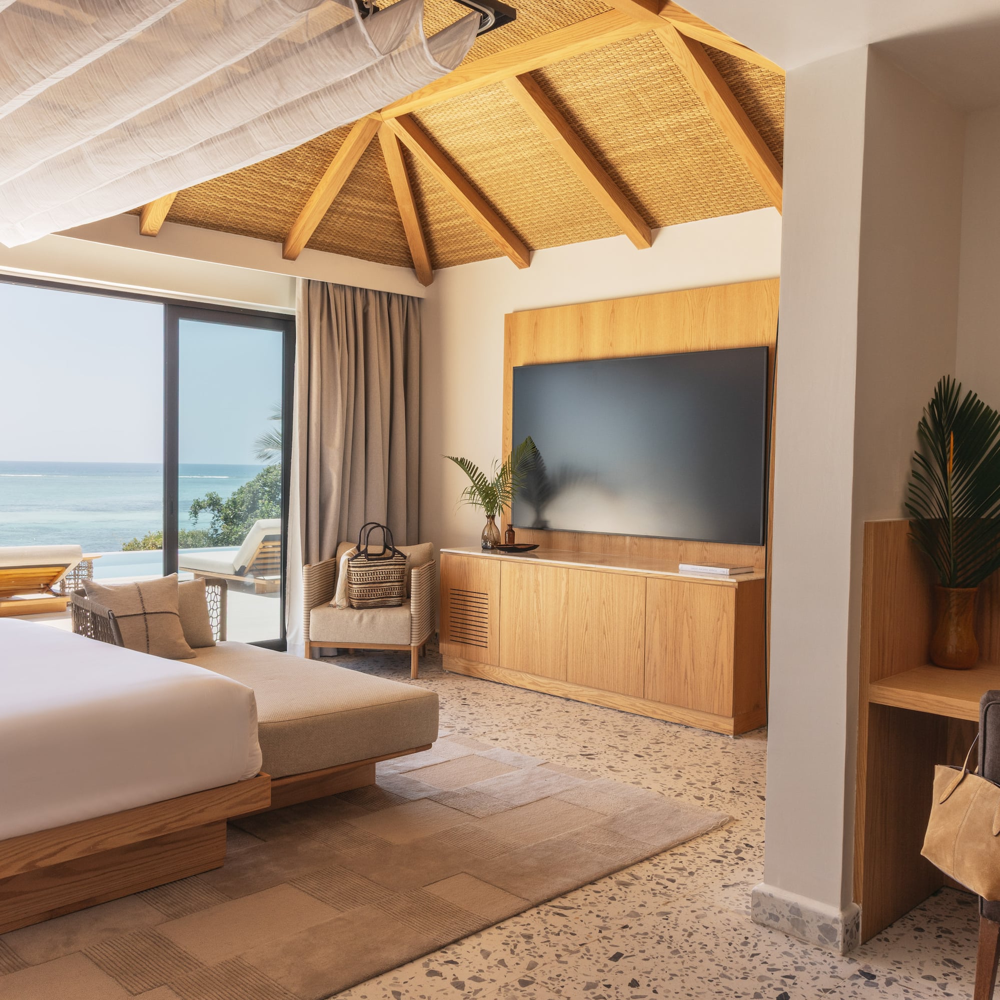 a room with a large bed and a television