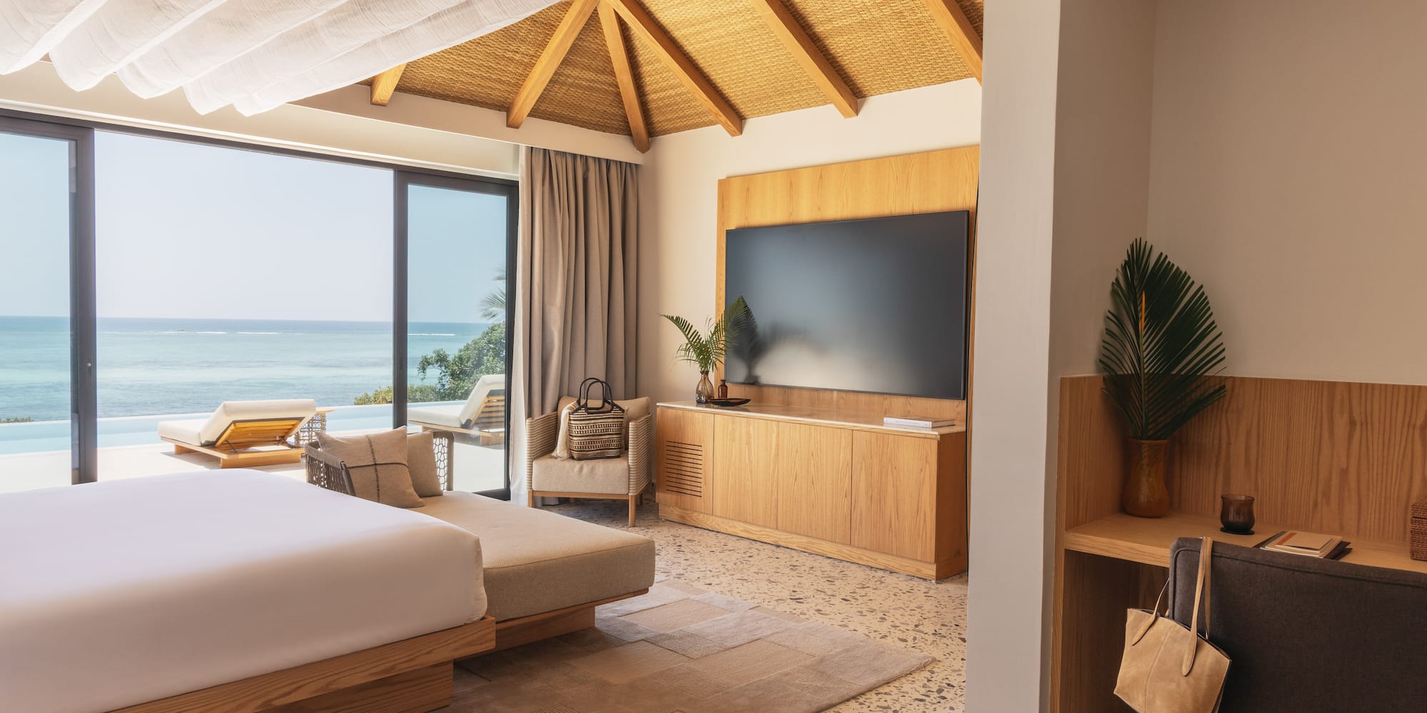 a room with a large bed and a television