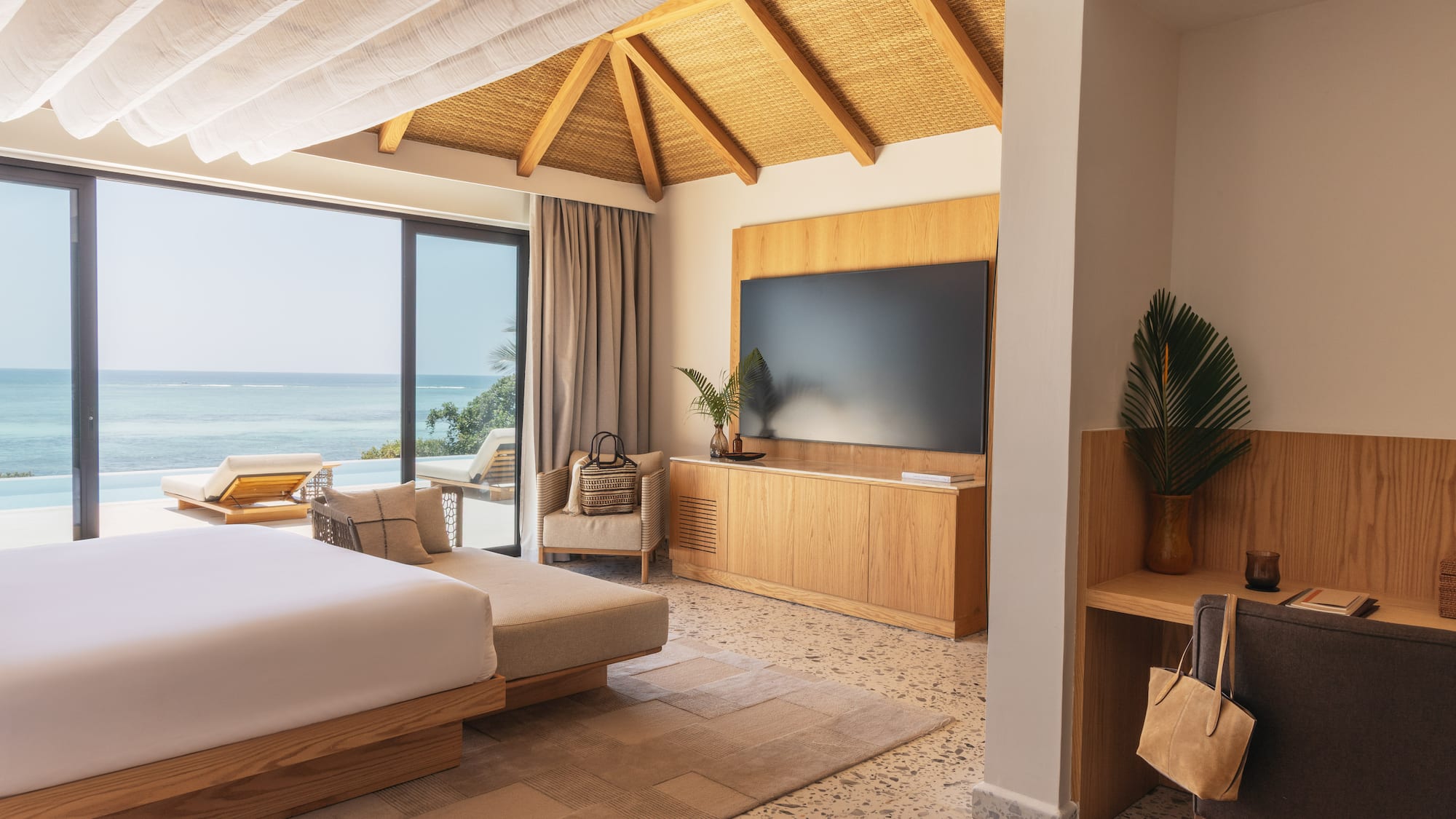 a room with a large bed and a television