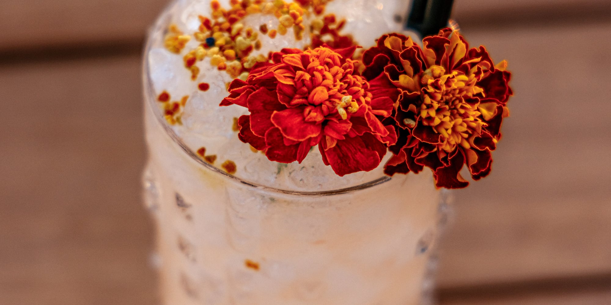 a glass with ice and flowers on top