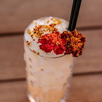 a glass with ice and flowers on top