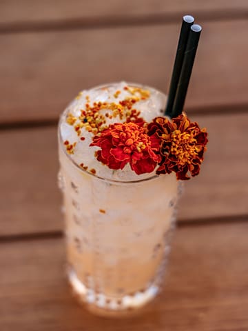 a glass with ice and flowers on top