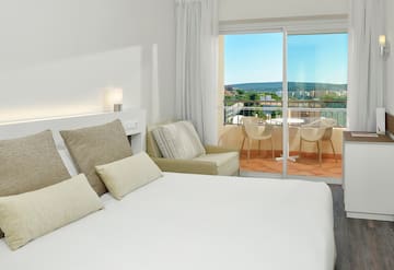 a bed with pillows and a glass door