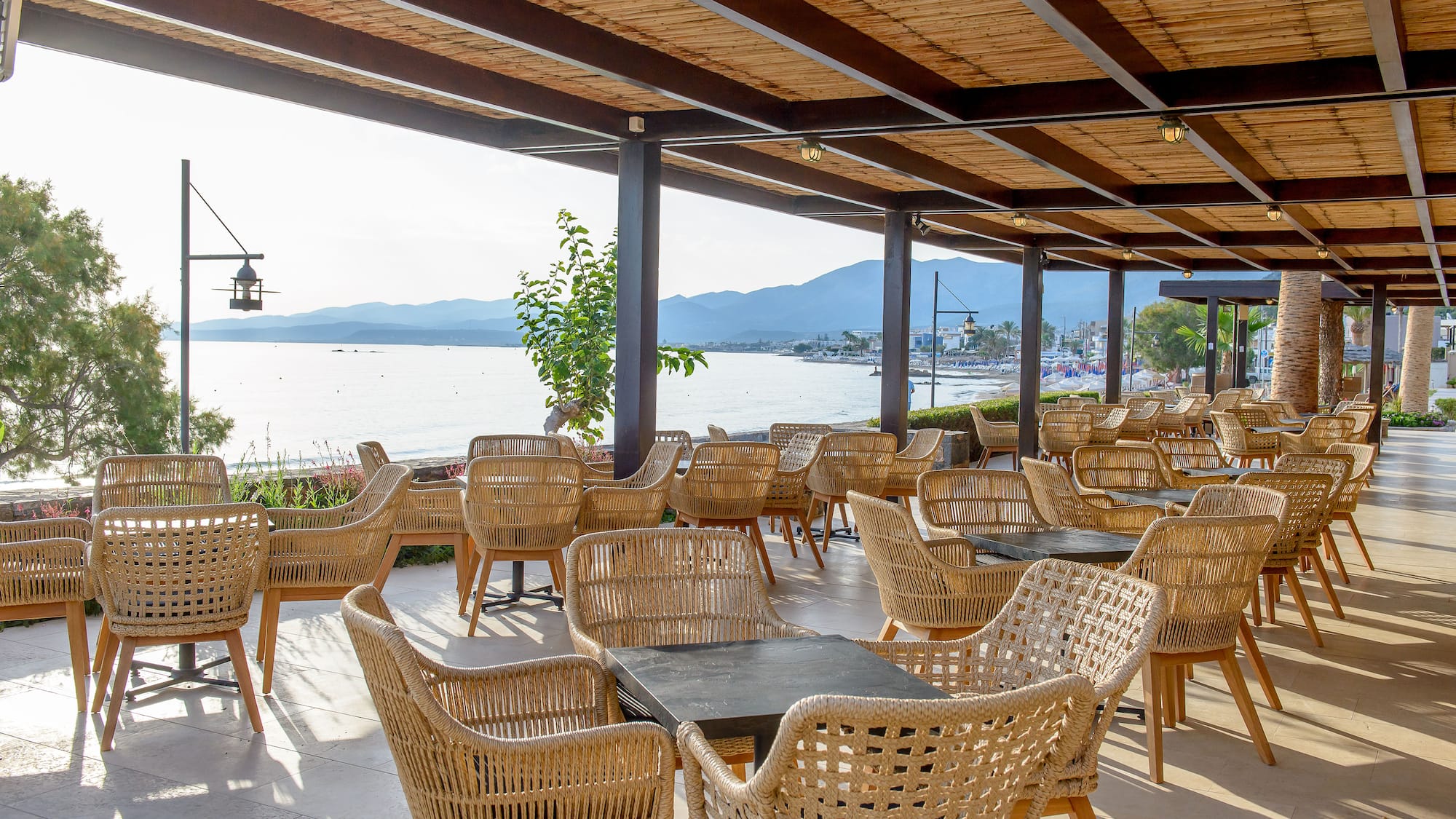 a covered patio with wicker chairs and tables