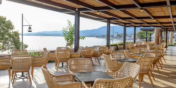 a covered patio with wicker chairs and tables