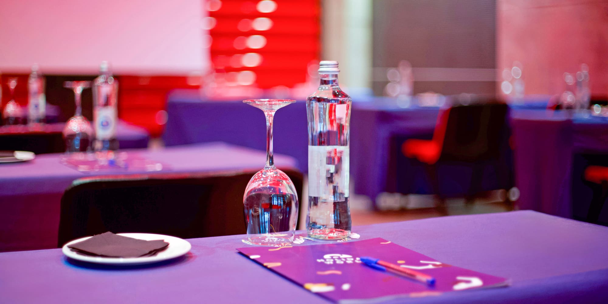 a table with wine glasses and a bottle on it