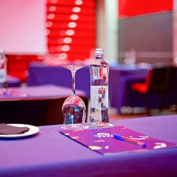 a table with wine glasses and a bottle on it