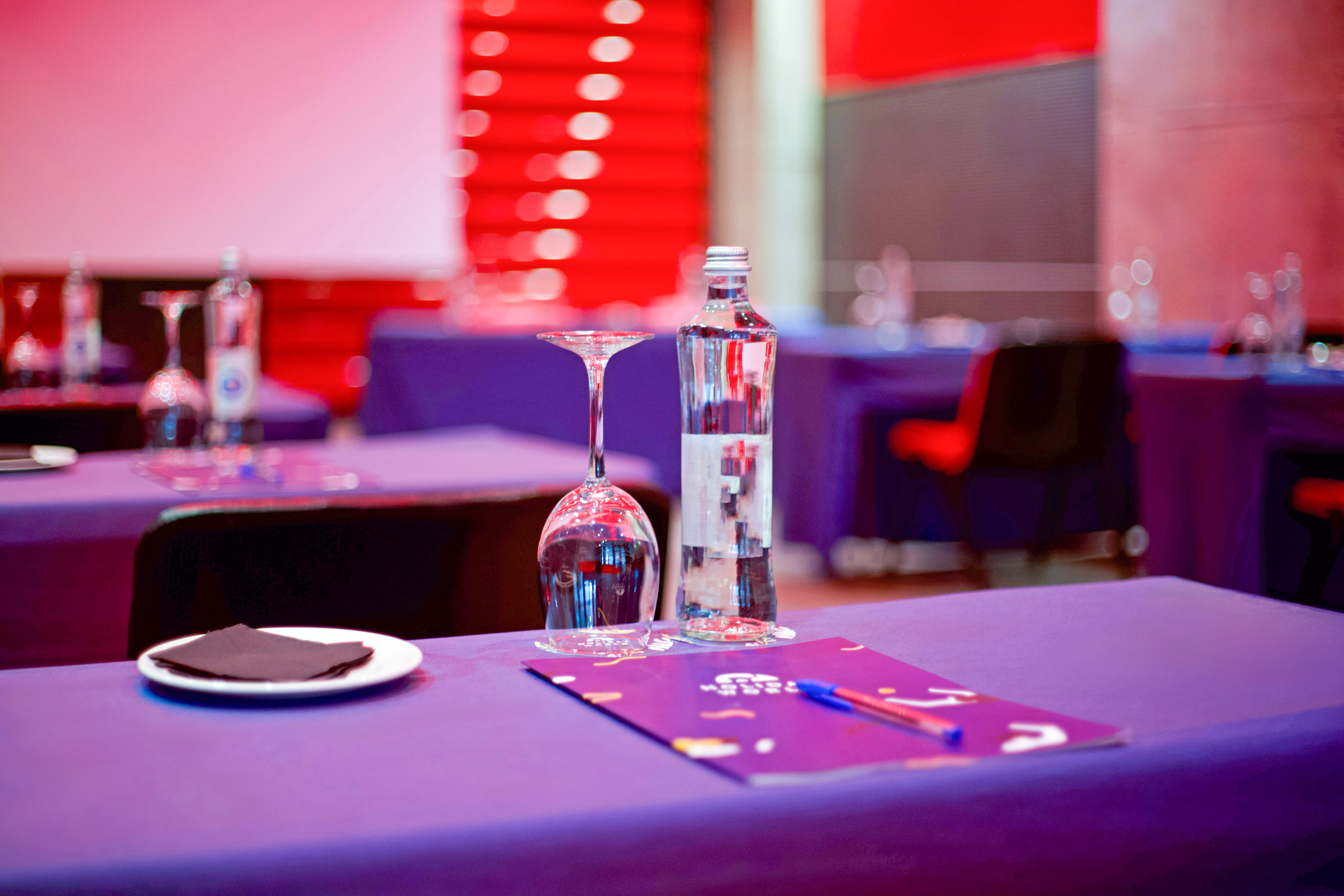 a table with wine glasses and a bottle on it