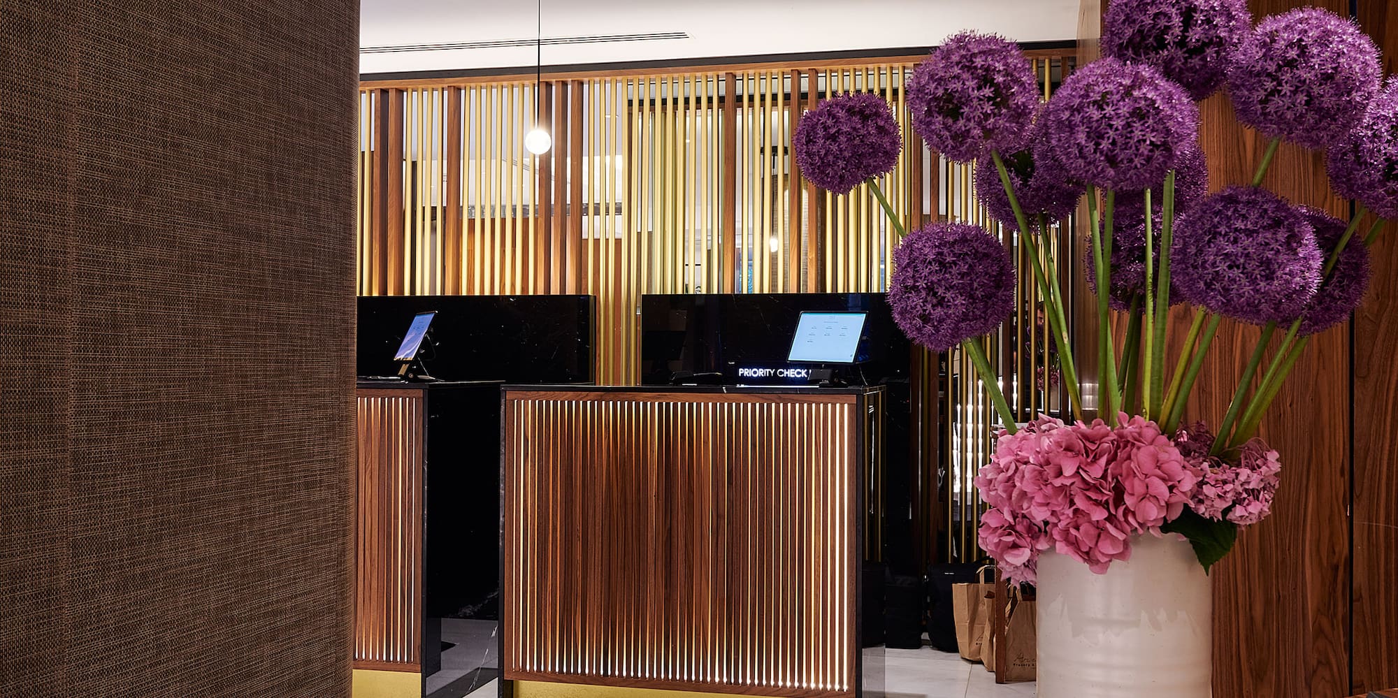 a vase of purple flowers in a room