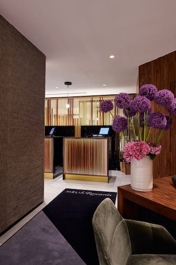 a vase of purple flowers in a room