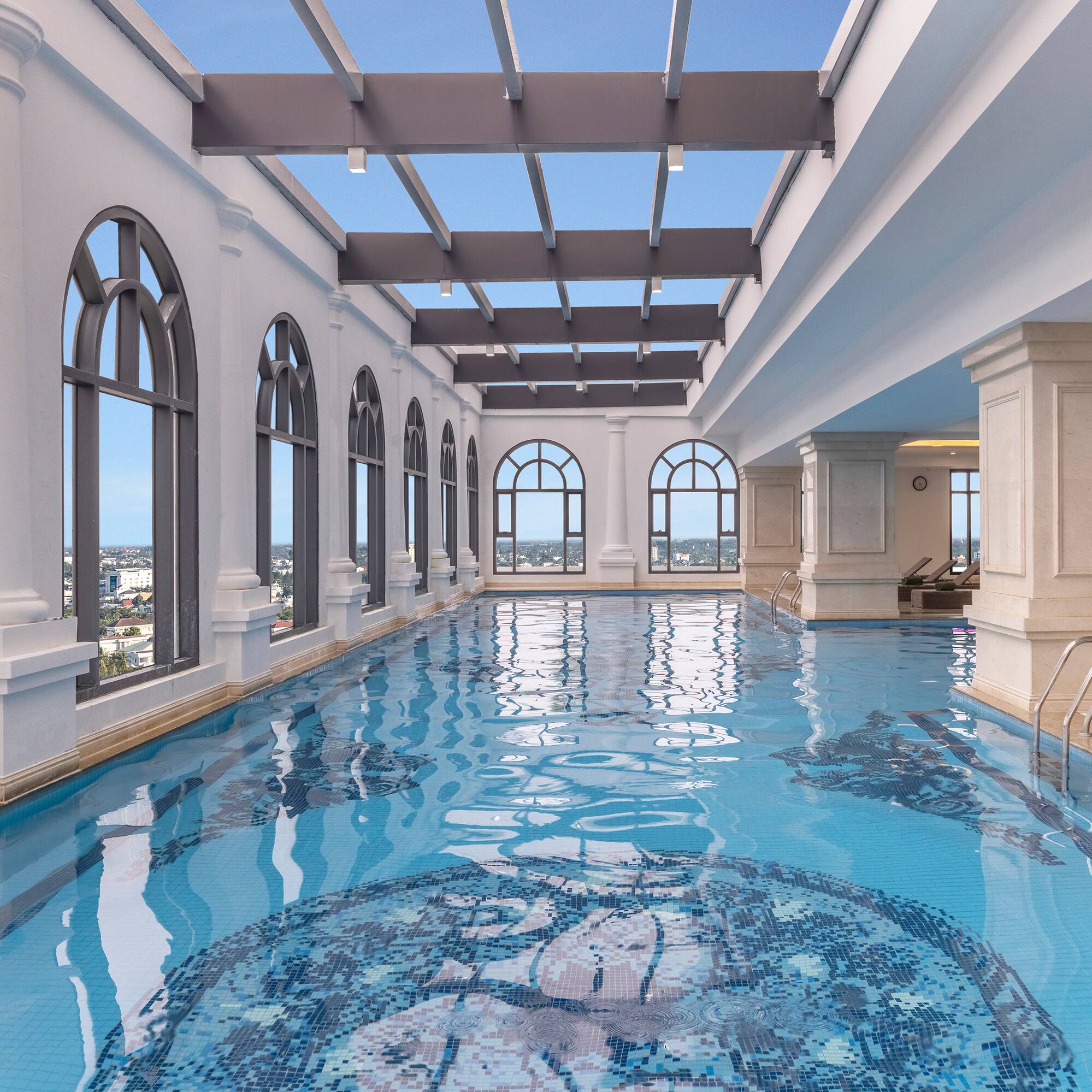 a indoor swimming pool with large windows