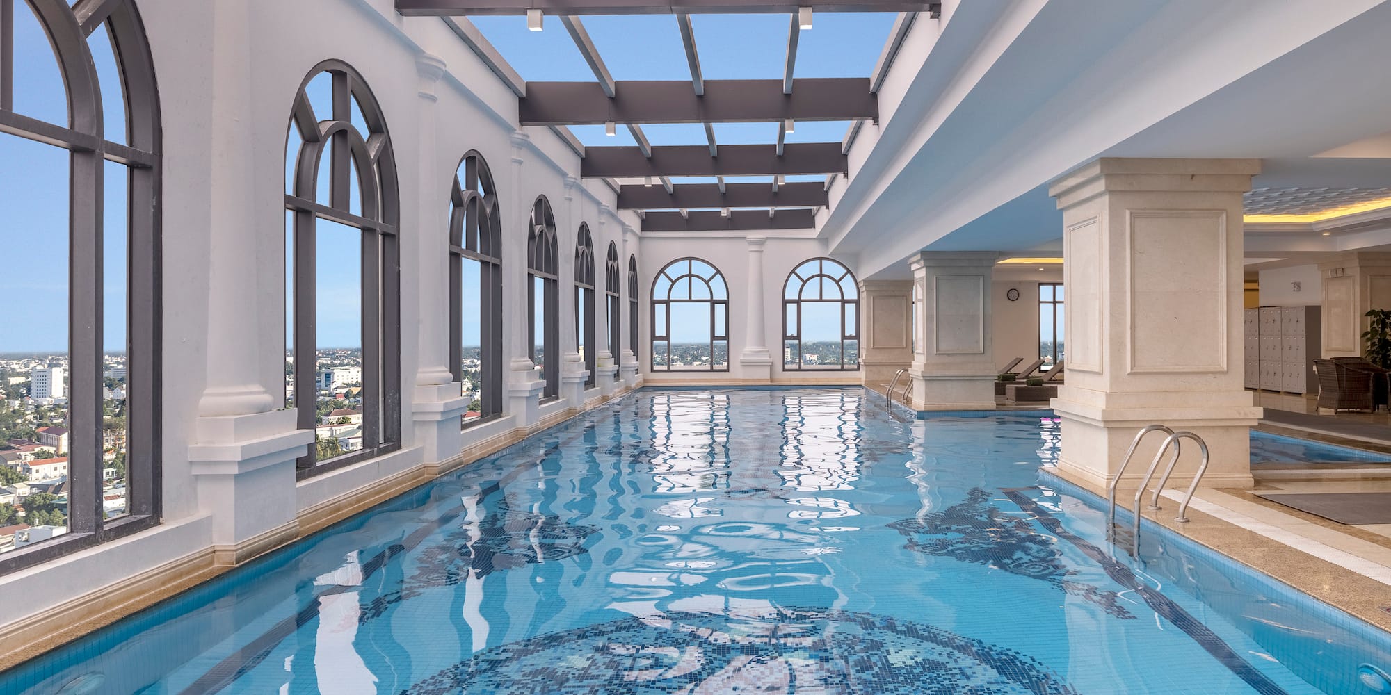 a indoor swimming pool with large windows